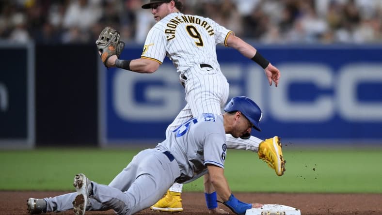 Sep 27, 2022; San Diego, California, USA; San Diego Padres second baseman Jake Cronenworth (9) forces out Los Angeles Dodgers catcher Austin Barnes (15) at second base to complete a double play during the third inning at Petco Park. Mandatory Credit: Orlando Ramirez-USA TODAY Sports