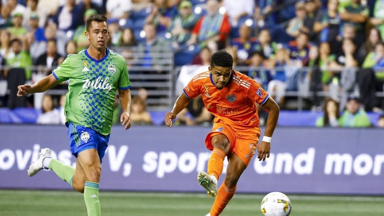 Sep 27, 2022; Seattle, Washington, USA; FC Cincinnati forward Brenner (9) scores a goal against Seattle Sounders FC defender Jackson Ragen (25) during the first half at Lumen Field. Mandatory Credit: Joe Nicholson-USA TODAY Sports
