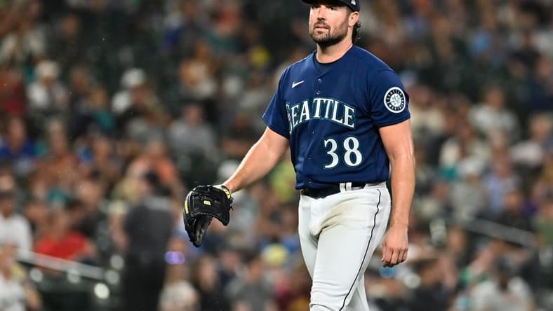 Sep 27, 2022; Seattle, Washington, USA; Seattle Mariners starting pitcher Robbie Ray (38) walks off the field after striking out Texas Rangers left fielder Bubba Thompson (65) (not pictured) to end the top of the fifth inning at T-Mobile Park. Mandatory Credit: Steven Bisig-USA TODAY Sports
