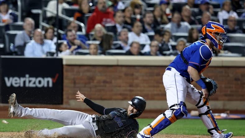 Sep 28, 2022; New York City, New York, USA; Miami Marlins second baseman Charles Leblanc (83) scores against New York Mets catcher Tomas Nido (3) on a double by Marlins right fielder Brian Anderson (not pictured) during the seventh inning at Citi Field. Mandatory Credit: Brad Penner-USA TODAY Sports