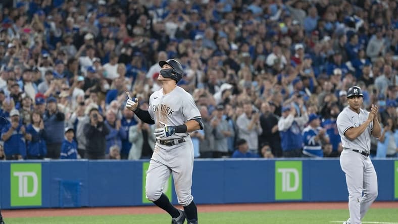 Sep 28, 2022; Toronto, Ontario, CAN; New York Yankees designated hitter Aaron Judge (99) celebratess after hitting his 61st home run scoring two runs against the Toronto Blue Jays during the seventh inning at Rogers Centre. Mandatory Credit: Nick Turchiaro-USA TODAY Sports
