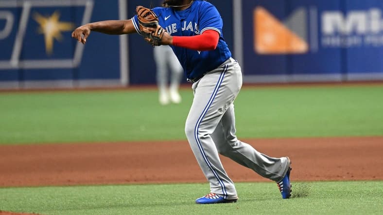 Sep 23, 2022; St. Petersburg, Florida, USA; Toronto Blue Jays first baseman Vladimir Guerrero Jr. (27) throws to third base in the eighth inning against the Tampa Bay Rays at Tropicana Field. Mandatory Credit: Jonathan Dyer-USA TODAY Sports