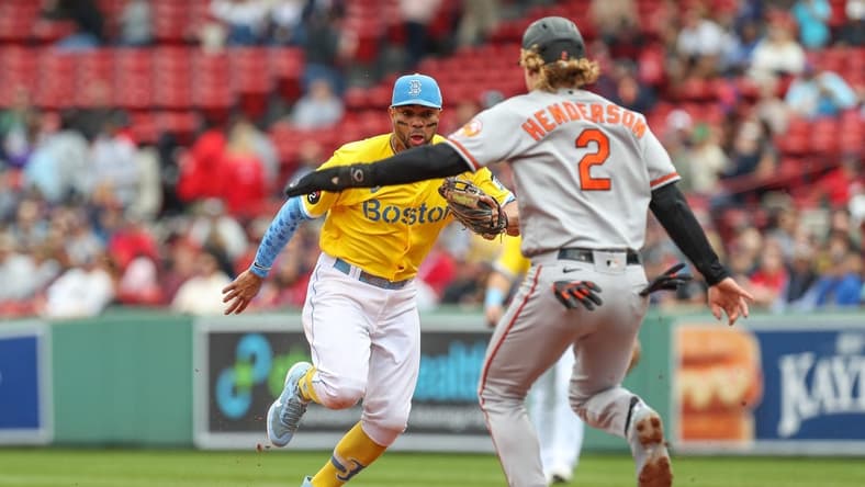 Sep 29, 2022; Boston, Massachusetts, USA; Boston Red Sox shortstop Xander Bogaerts (2) beats Baltimore Orioles third baseman Gunnar Henderson (2) to second base for an out during the second inning at Fenway Park. Mandatory Credit: Paul Rutherford-USA TODAY Sports