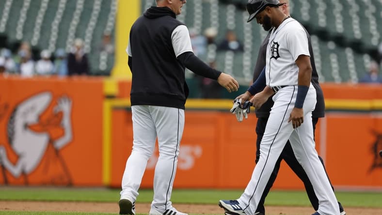 Sep 29, 2022; Detroit, Michigan, USA; Detroit Tigers right fielder Willi Castro (9) walks off the field with Detroit Tigers manager A.J. Hinch (14) after an injury in the fourth inning against the Kansas City Royals at Comerica Park. Mandatory Credit: Rick Osentoski-USA TODAY Sports