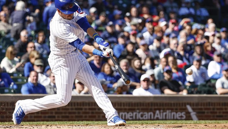 Sep 29, 2022; Chicago, Illinois, USA; Chicago Cubs third baseman Patrick Wisdom (16) hits an RBI double against the Philadelphia Phillies during the first inning at Wrigley Field. Mandatory Credit: Kamil Krzaczynski-USA TODAY Sports