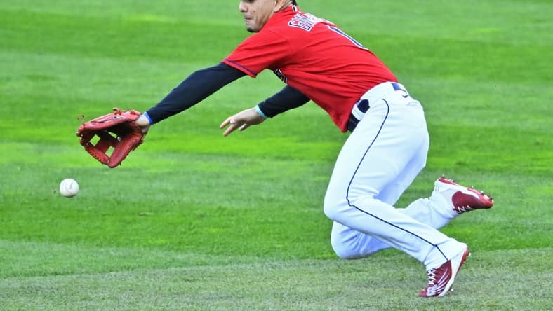Sep 29, 2022; Cleveland, Ohio, USA; Cleveland Guardians second baseman Andres Gimenez (0) reaches for the ball against the Tampa Bay Rays in the first inning at Progressive Field. Mandatory Credit: David Richard-USA TODAY Sports