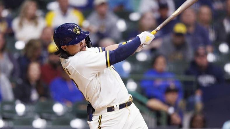 Sep 29, 2022; Milwaukee, Wisconsin, USA; Milwaukee Brewers first baseman Keston Hiura (18) hits an RBI double during the second inning against the Miami Marlins at American Family Field. Mandatory Credit: Jeff Hanisch-USA TODAY Sports