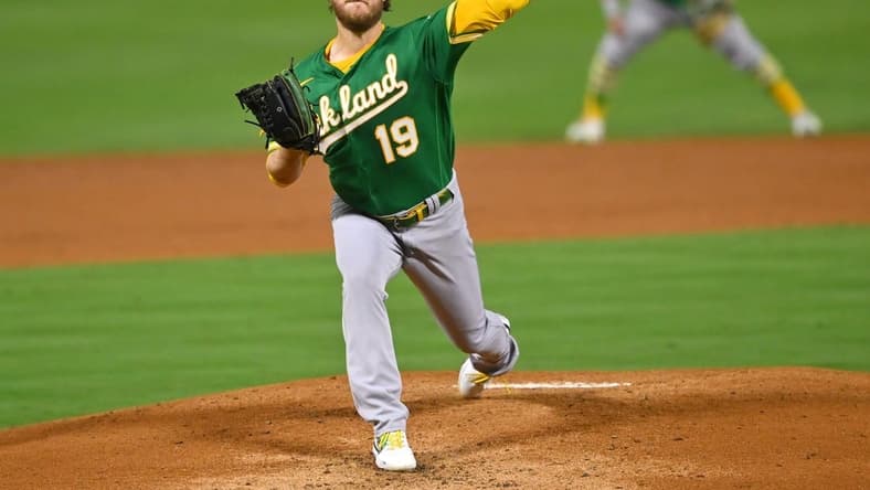 Sep 29, 2022; Anaheim, California, USA; Oakland Athletics starting pitcher Cole Irvin (19) throws to the plate in the first inning against the Los Angeles Angels at Angel Stadium. Mandatory Credit: Jayne Kamin-Oncea-USA TODAY Sports