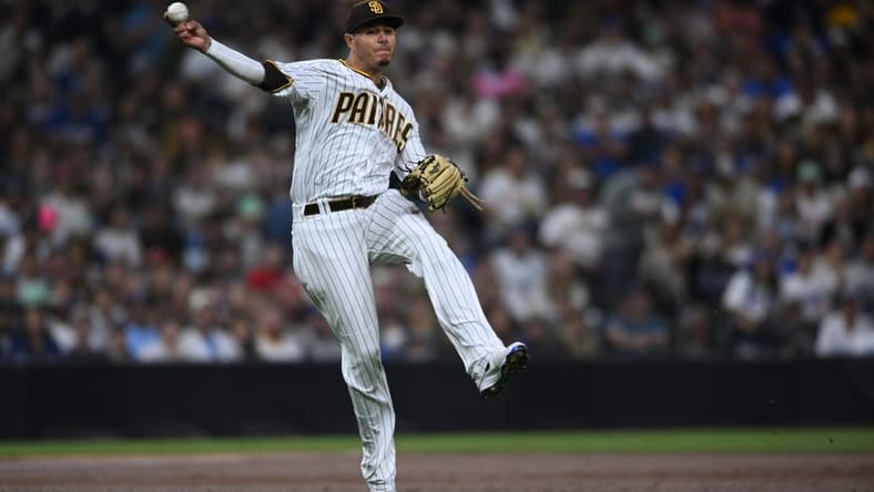 Sep 29, 2022; San Diego, California, USA; San Diego Padres third baseman Manny Machado (13) throws to first base late on a single hit by Los Angeles Dodgers shortstop Trea Turner (not pictured) during the second inning at Petco Park. Mandatory Credit: Orlando Ramirez-USA TODAY Sports