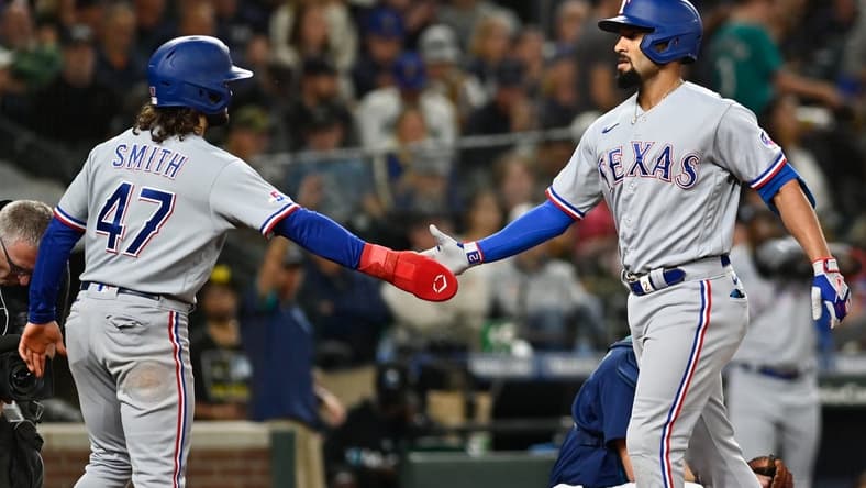 Sep 29, 2022; Seattle, Washington, USA; Texas Rangers second baseman Marcus Semien (2) is greeted by shortstop Josh Smith (47) after hitting a two run home run against the Seattle Mariners during the third inning at T-Mobile Park. Mandatory Credit: Steven Bisig-USA TODAY Sports