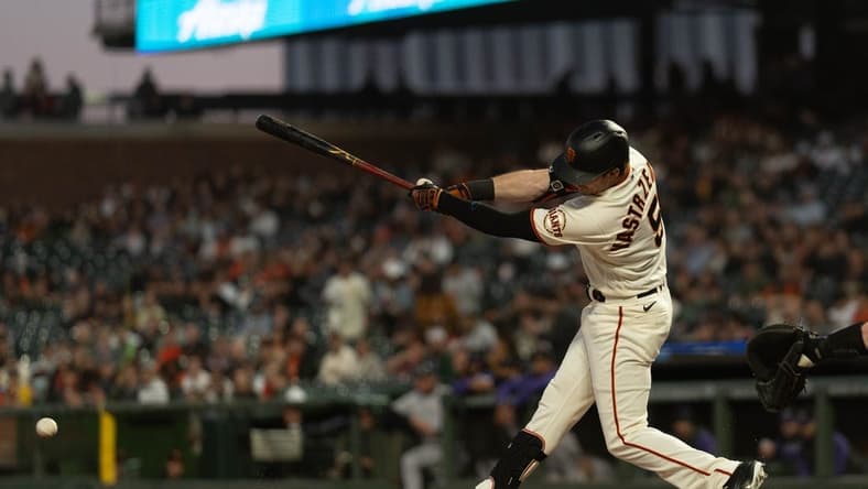 Sep 29, 2022; San Francisco, California, USA; San Francisco Giants center fielder Mike Yastrzemski (5) hits a single during the first inning against the Colorado Rockies at Oracle Park. Mandatory Credit: Stan Szeto-USA TODAY Sports
