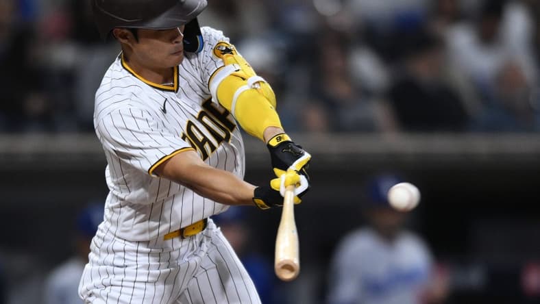 Sep 29, 2022; San Diego, California, USA; San Diego Padres shortstop Ha-Seong Kim (7) hits a single against the Los Angeles Dodgers during the eighth inning at Petco Park. Mandatory Credit: Orlando Ramirez-USA TODAY Sports