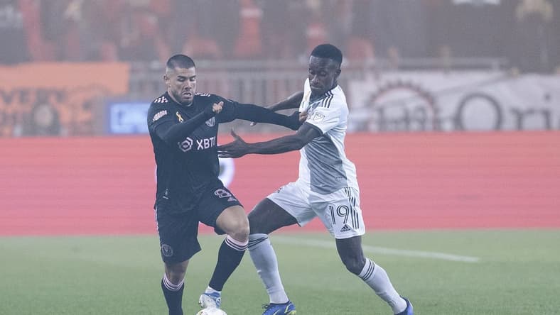 Sep 30, 2022; Toronto, Ontario, CAN; Toronto FC defender Richie Laryea (19) battles for the ball with Inter Miami midfielder Alejandro Pozuelo (8) during the first half at BMO Field. Mandatory Credit: Nick Turchiaro-USA TODAY Sports