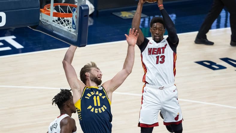 Mar 31, 2021; Indianapolis, Indiana, USA; Miami Heat center Bam Adebayo (13) rebounds the ball over Indiana Pacers forward Domantas Sabonis (11) during the first quarter at Bankers Life Fieldhouse. Mandatory Credit: Trevor Ruszkowski-USA TODAY Sports