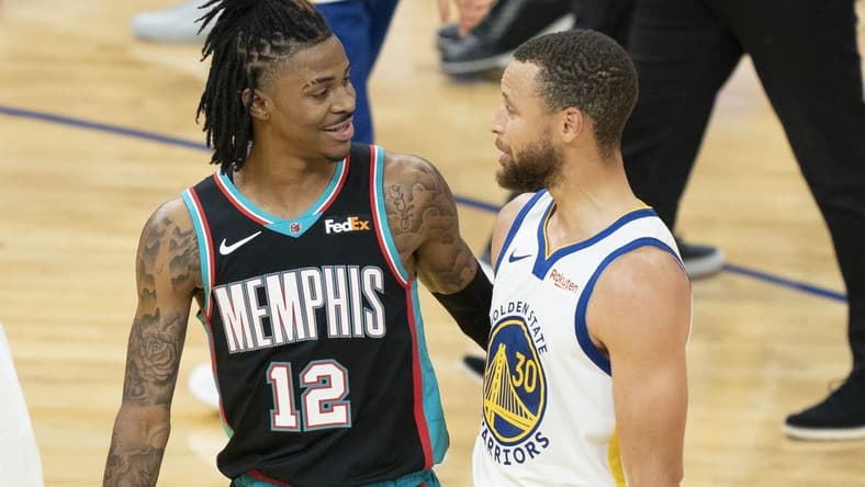 May 16, 2021; San Francisco, California, USA; Memphis Grizzlies guard Ja Morant (12) talks to Golden State Warriors guard Stephen Curry (30) after the game at Chase Center. Mandatory Credit: Kyle Terada-USA TODAY Sports