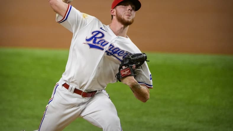 Sep 28, 2021; Arlington, Texas, USA; Texas Rangers starting pitcher A.J. Alexy (62) pitches against the Los Angeles Angels during the first inning at Globe Life Field. Mandatory Credit: Jerome Miron-USA TODAY Sports