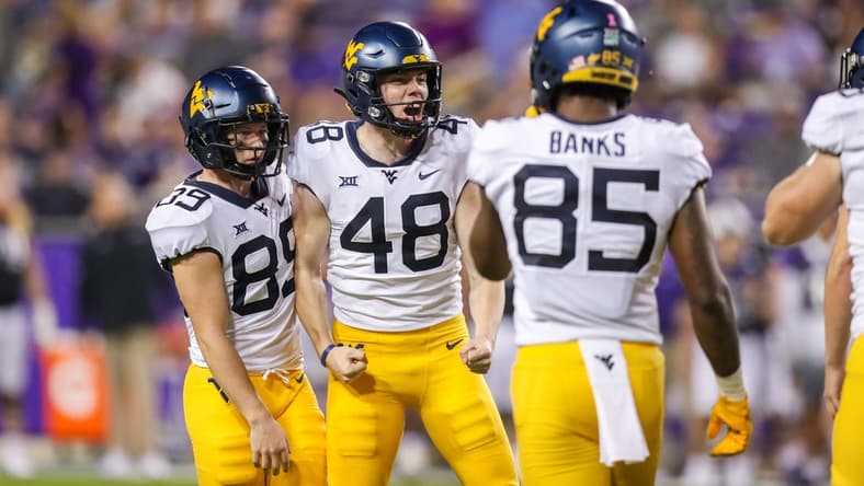 Oct 23, 2021; Fort Worth, Texas, USA; West Virginia Mountaineers place kicker Casey Legg (48) celebrates with teammates following a made field goal during the third quarter against the TCU Horned Frogs at Amon G. Carter Stadium. Mandatory Credit: Ben Queen-USA TODAY Sports