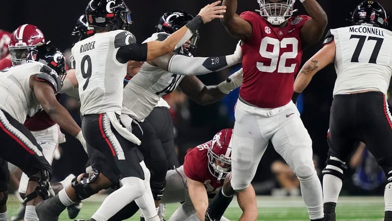 Alabama defensive lineman Justin Eboigbe (92) pressures Cincinnati quarterback Desmond Ridder (9) as he throws during the 2021 College Football Playoff Semifinal game at the 86th Cotton Bowl in AT&T Stadium in Arlington, Texas Friday, Dec. 31, 2021. Alabama defeated Cincinnati 27-6 to advance to the national championship game. [Staff Photo/Gary Cosby Jr.]

College Football Playoffs Alabama Vs Cincinnati