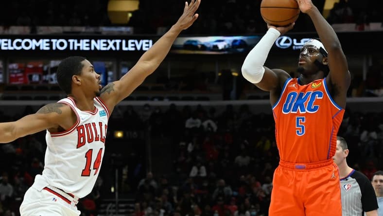 Feb 12, 2022; Chicago, Illinois, USA;  Chicago Bulls forward Malcolm Hill (14) defends against Oklahoma City Thunder forward Luguentz Dort (5) during the second half at the United Center. Mandatory Credit: Matt Marton-USA TODAY Sports