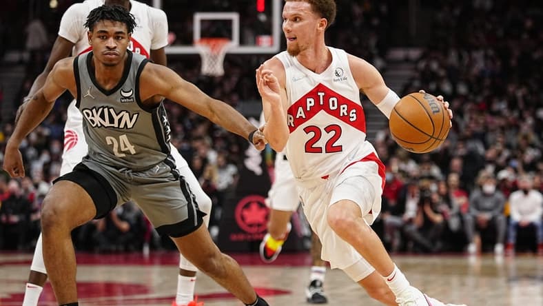 Mar 1, 2022; Toronto, Ontario, CAN; Toronto Raptors guard Malachi Flynn (22) drives to the net against Brooklyn Nets guard Cam Thomas (24) during the second half at Scotiabank Arena. Mandatory Credit: John E. Sokolowski-USA TODAY Sports