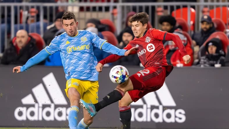 Apr 16, 2022; Toronto, Ontario, CAN; Toronto FC defender Kadin Chung (12) battles for the ball against Philadelphia Union defender Jack Elliott (3) at BMO Field. Mandatory Credit: Kevin Sousa-USA TODAY Sports