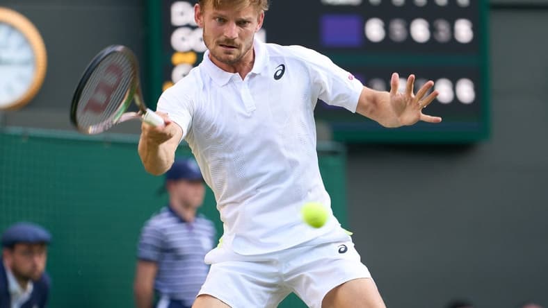 Jul 5, 2022; London, England, United Kingdom; David Goffin (BEL) returns a shot against Cameron Norrie (GBR) during a quarterfinals mens singles match on Number one court at the 2022 Wimbledon Championships at All England Lawn Tennis and Croquet Club. Mandatory Credit: Peter van den Berg-USA TODAY Sports