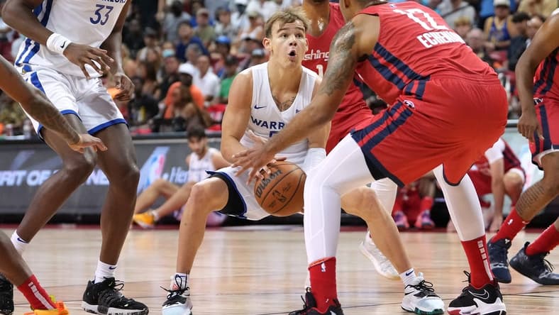 Jul 17, 2022; Las Vegas, NV, USA; Golden State Warriors guard Mac McClung (55) looks to shoot past Washington Wizards center Jaime Echenique (12) during a NBA Summer League game at Thomas & Mack Center. Mandatory Credit: Stephen R. Sylvanie-USA TODAY Sports