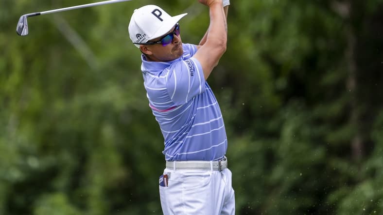 Jul 29, 2022; Detroit, Michigan, USA; Rickie Fowler hits his tee shot on the par 3 ninth hole during the second round of the Rocket Mortgage Classic golf tournament. Mandatory Credit: Raj Mehta-USA TODAY Sports
