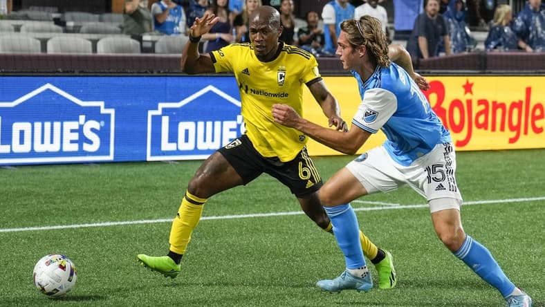 Jul 30, 2022; Charlotte, North Carolina, USA; Columbus Crew midfielder Darlington Nagbe (6) and Charlotte FC midfielder Benjamin Bender (15) chase down the ball during the first half at Bank of America Stadium. Mandatory Credit: Jim Dedmon-USA TODAY Sports