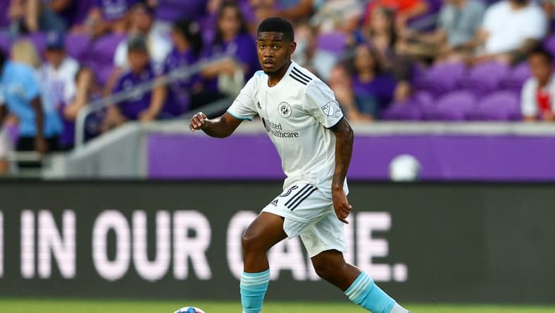 Aug 6, 2022; Orlando, Florida, USA;  New England Revolution midfielder Maciel (13) controls the ball against Orlando City in the first half at Exploria Stadium. Mandatory Credit: Nathan Ray Seebeck-USA TODAY Sports