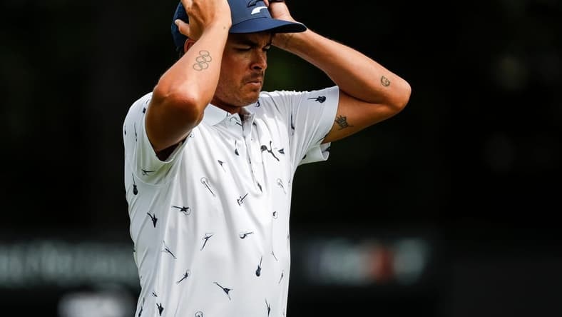 Rickie Fowler puts on his cap as he walks off the 9th green during Round 1 of the Rocket Mortgage Classic at the Detroit Golf Club in Detroit on Thurs., July 28, 2022.

Syndication Detroit Free Press