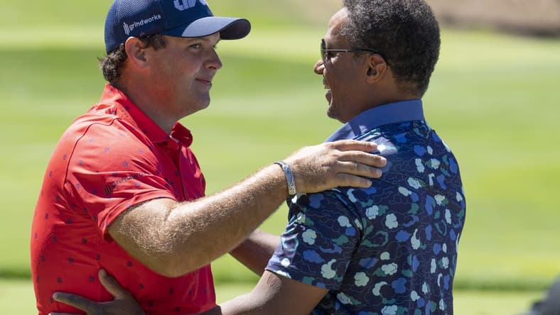 Sep 2, 2022; Boston, Massachusetts, USA; Patrick Reed (left) is greeted by LIV Golf Managing Director Majed Al Sorour before the start of the first round of the LIV Golf tournament at The International. Mandatory Credit: Richard Cashin-USA TODAY Sports