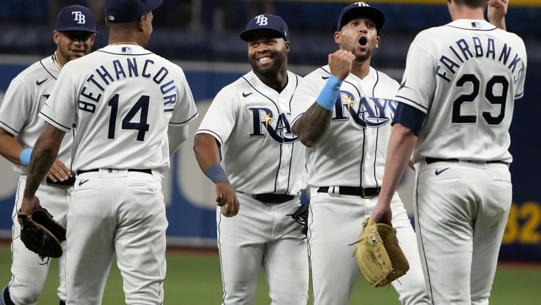 Sep 7, 2022; St. Petersburg, Florida, USA; Tampa Bay Rays relief pitcher Pete Fairbanks (29) (right) is congratulated by left fielder David Peralta (6) (second from right) and right fielder Manuel Margot (13) after the Rays defeated the Boston Red Sox at Tropicana Field. Mandatory Credit: Dave Nelson-USA TODAY Sports