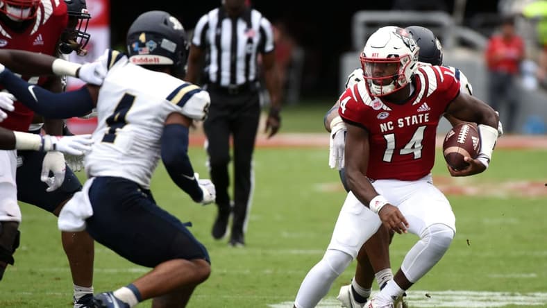 Sep 10, 2022; Raleigh, North Carolina, USA; North Carolina State Wolfpack quarterback Jack Chambers (14) runs the ball during the second half against the Charleston Southern Buccaneers at Carter-Finley Stadium. Mandatory Credit: Rob Kinnan-USA TODAY Sports