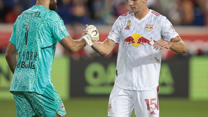 Sep 10, 2022; Harrison, New Jersey, USA;  New York Red Bulls goalkeeper Carlos Miguel Coronel (1) celebrates with defender Sean Nealis (15) after defeating New England Revolution at Red Bull Arena. Mandatory Credit: Vincent Carchietta-USA TODAY Sports