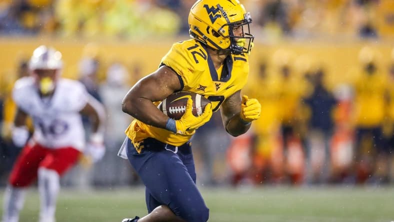 Sep 10, 2022; Morgantown, West Virginia, USA; West Virginia Mountaineers running back CJ Donaldson (12) runs the ball during the third quarter against the Kansas Jayhawks at Mountaineer Field at Milan Puskar Stadium. Mandatory Credit: Ben Queen-USA TODAY Sports