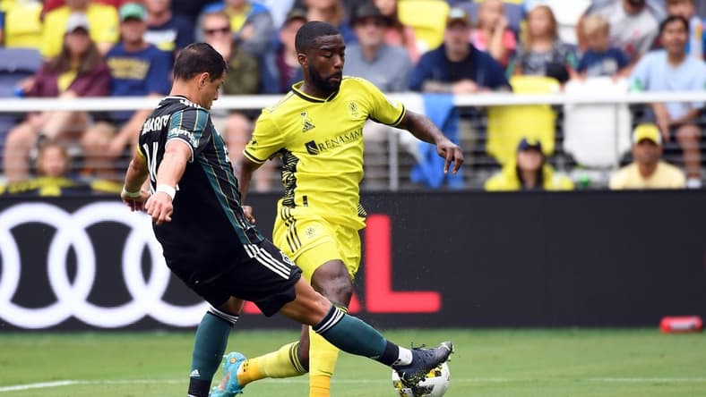 Sep 10, 2022; Nashville, Tennessee, USA; Nashville SC defender Shaq Moore (18) handles the ball away from Los Angeles Galaxy forward Javier Hernandez (14) during the first half at Geodis Park. Mandatory Credit: Christopher Hanewinckel-USA TODAY Sports
