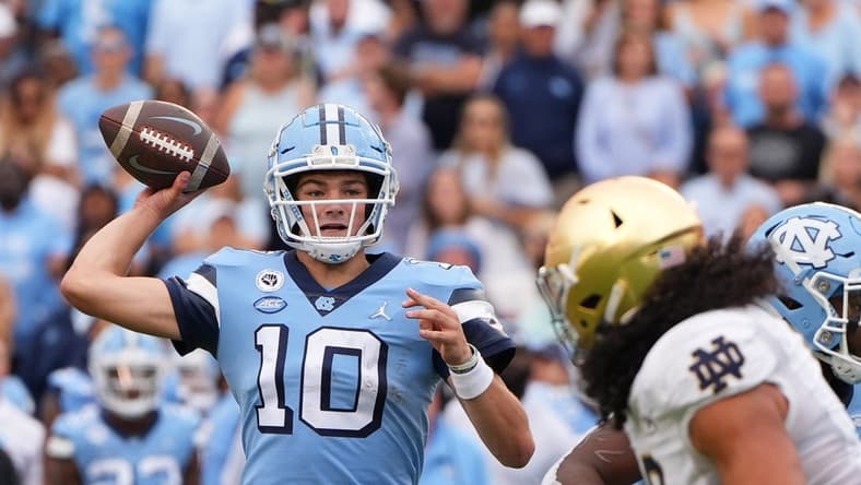 Sep 24, 2022; Chapel Hill, North Carolina, USA; North Carolina Tar Heels quarterback Drake Maye (10) looks to pass Notre Dame Fighting Irish linebacker Marist Liufau (8) pressures in the second quarter at Kenan Memorial Stadium. Mandatory Credit: Bob Donnan-USA TODAY Sports