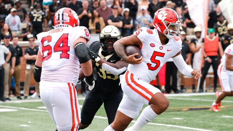 Sep 24, 2022; Winston-Salem, North Carolina, USA;  Clemson Tigers quarterback DJ Uiagalelei (5) runs the ball between  offensive lineman Walker Parks (64) and Wake Forest Demon Deacons defensive lineman Kendron Wayman (35) during the second quarter at Truist Field. Mandatory Credit: Reinhold Matay-USA TODAY Sports