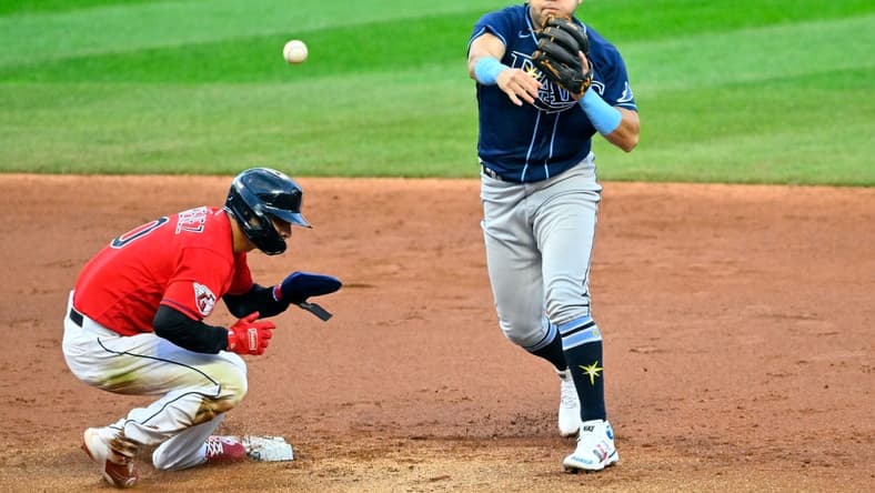Sep 29, 2022; Cleveland, Ohio, USA; Tampa Bay Rays second baseman Jonathan Aranda (62) throws to first base after forcing out of Cleveland Guardians second baseman Andres Gimenez (0) in the second inning at Progressive Field. Mandatory Credit: David Richard-USA TODAY Sports