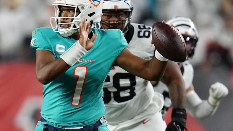 Sep 29, 2022; Cincinnati, Ohio, USA; Miami Dolphins quarterback Tua Tagovailoa (1) is pursued by Cincinnati Bengals defensive tackle Josh Tupou (68) in the second quarter against the Cincinnati Bengals at Paycor Stadium. Mandatory Credit: Sam Greene/Cincinnati Enquirer via USA TODAY NETWORK