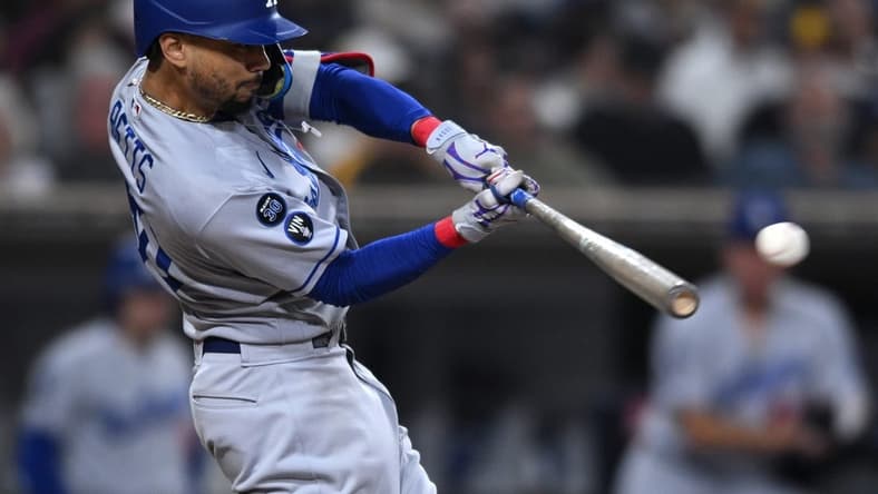 Sep 29, 2022; San Diego, California, USA; Los Angeles Dodgers right fielder Mookie Betts (50) hits a double against the San Diego Padres during the sixth inning at Petco Park. Mandatory Credit: Orlando Ramirez-USA TODAY Sports