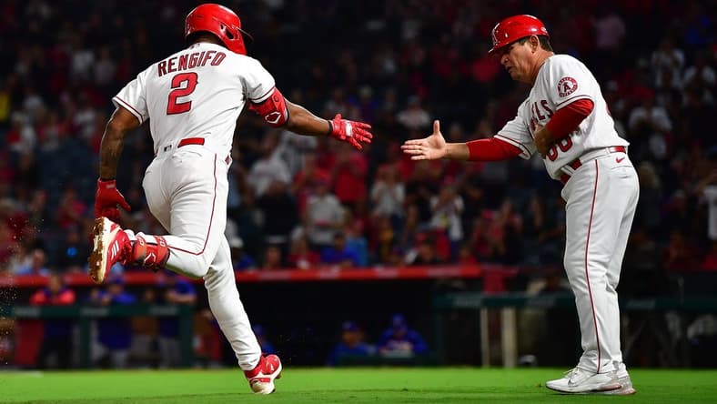 Sep 30, 2022; Anaheim, California, USA; Los Angeles Angels third baseman Luis Rengifo (2) is greeted by third base coach Mike Gallego (86) after hitting a solo home run against the Texas Rangers during the third inning at Angel Stadium. Mandatory Credit: Gary A. Vasquez-USA TODAY Sports
