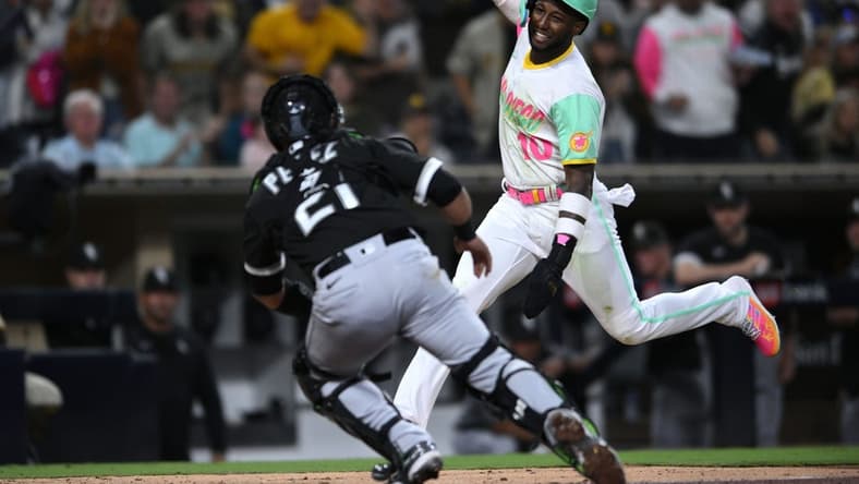 Sep 30, 2022; San Diego, California, USA; San Diego Padres left fielder Jurickson Profar (10) is tagged out at home by Chicago White Sox catcher Carlos Perez (21) during the fifth inning at Petco Park. Mandatory Credit: Orlando Ramirez-USA TODAY Sports