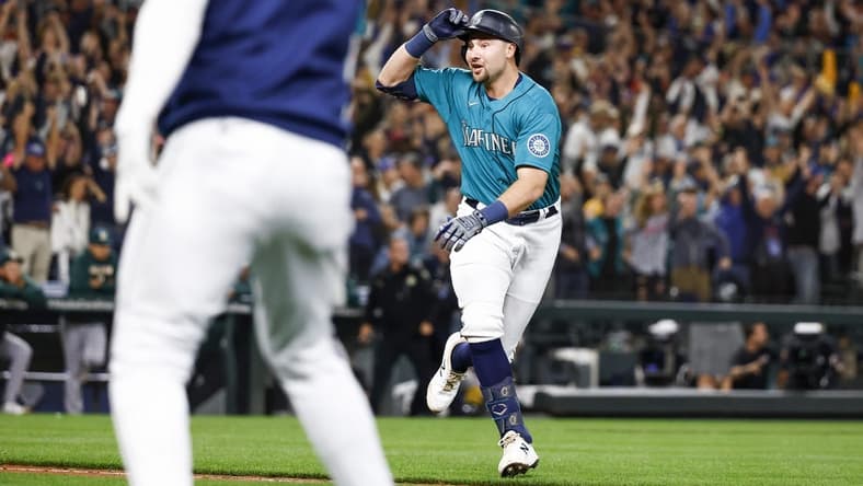 Sep 30, 2022; Seattle, Washington, USA; Seattle Mariners catcher Cal Raleigh (29) reacts after hitting a walk-off solo-home run against the Oakland Athletics during the ninth inning at T-Mobile Park. Seattle defeated Oakland 2-1, clinching a wild card and ending a 21-year playoff drought. Mandatory Credit: Joe Nicholson-USA TODAY Sports