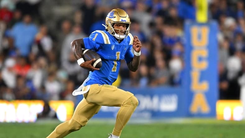 Sep 30, 2022; Pasadena, California, USA; UCLA Bruins quarterback Dorian Thompson-Robinson (1) runs for a 4 yard gain in the first half against the Washington Huskies at the Rose Bowl. Mandatory Credit: Jayne Kamin-Oncea-USA TODAY Sports