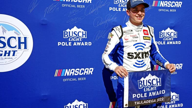 Oct 1, 2022; Talladega, Alabama, USA; NASCAR Cup Series driver Christopher Bell (20) celebrates winning the pole during qualifying for the YellaWood 500 at Talladega Superspeedway. Mandatory Credit: John David Mercer-USA TODAY Sports