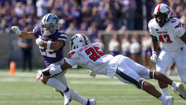 Oct 1, 2022; Manhattan, Kansas, USA; Kansas State Wildcats running back Deuce Vaughn (22) runs against Texas Tech Red Raiders defensive back Dadrion Taylor-Demerson (25) during the first quarter at Bill Snyder Family Football Stadium. Mandatory Credit: Scott Sewell-USA TODAY Sports