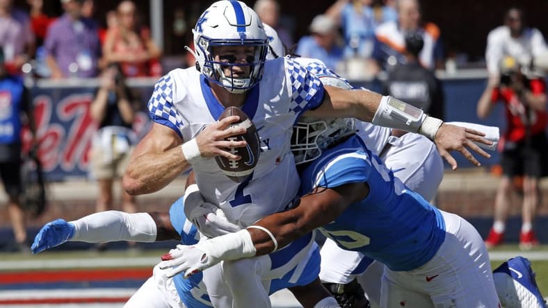 Oct 1, 2022; Oxford, Mississippi, USA; Kentucky Wildcats quarterback Will Levis (7) scrambles in the back field as Mississippi Rebels defensive end Tavius Robinson (95) attempts to make the tackle during the second quarter at Vaught-Hemingway Stadium. Mandatory Credit: Petre Thomas-USA TODAY Sports