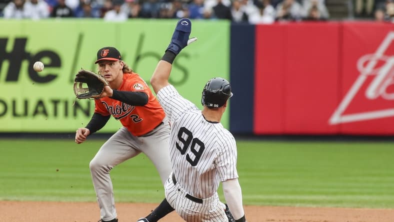 Oct 1, 2022; Bronx, New York, USA; New York Yankees right fielder Aaron Judge (99) is forced our at second base by Baltimore Orioles third baseman Gunnar Henderson (2) in the first inning at Yankee Stadium. Mandatory Credit: Wendell Cruz-USA TODAY Sports